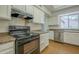 Bright kitchen features white cabinets, neutral counters, and stainless steel appliances, offering a clean, functional space at 945 N Pasadena -- # 84, Mesa, AZ 85201