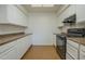 Updated kitchen featuring white cabinets, countertop, and modern appliances at 945 N Pasadena -- # 84, Mesa, AZ 85201