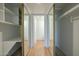 Spacious walk-in closet with mirrored doors, built-in shelving, and access to ensuite bathroom at 945 N Pasadena -- # 84, Mesa, AZ 85201