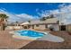 Backyard features an in-ground pool, desert landscaping, covered patio, and outdoor grill at 10208 W Highland Ave, Phoenix, AZ 85037