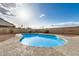 Backyard showcases a sparkling blue swimming pool with concrete border and block fence providing privacy at 10208 W Highland Ave, Phoenix, AZ 85037