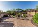 Spacious backyard features a patio with multiple seating areas, desert landscaping, and a pergola at 1322 W Spur Dr, Phoenix, AZ 85085