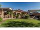 Spacious backyard features a turf area, outdoor kitchen, pergola, and privacy fence at 1322 W Spur Dr, Phoenix, AZ 85085