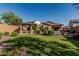 Spacious backyard features a turf area, outdoor kitchen, pergola, and privacy fence at 1322 W Spur Dr, Phoenix, AZ 85085