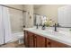 Bright bathroom featuring double sinks, updated fixtures, and a shower/tub combo at 1322 W Spur Dr, Phoenix, AZ 85085