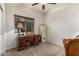 Bedroom with a wooden desk, chair, secure safe, and a neutral carpet at 1322 W Spur Dr, Phoenix, AZ 85085