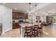 Eat-in kitchen featuring granite counters, dark cabinets, and island seating overlooking the Gathering room at 1322 W Spur Dr, Phoenix, AZ 85085