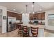 Open kitchen boasts granite countertops, stainless appliances, large island with seating, and ample cabinet space at 1322 W Spur Dr, Phoenix, AZ 85085