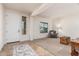 Bright and airy living room with neutral colors, tile flooring and a cozy armchair by the window at 1322 W Spur Dr, Phoenix, AZ 85085