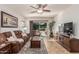 Comfortable Gathering room with plush seating, a ceiling fan, tile floors, and a sliding door to the backyard at 1322 W Spur Dr, Phoenix, AZ 85085
