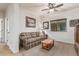 Cozy living room features a plaid sofa, side tables, natural light, and neutral carpet at 1322 W Spur Dr, Phoenix, AZ 85085