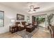 Comfortable Gathering room with plush seating, a ceiling fan, tile floors, and a sliding door to the backyard at 1322 W Spur Dr, Phoenix, AZ 85085