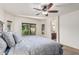 Spacious main bedroom with ceiling fan, carpet floors, and lots of natural light from large windows at 1322 W Spur Dr, Phoenix, AZ 85085