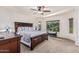 Relaxing main bedroom with large bed, ceiling fan, neutral colors, and natural light from the windows at 1322 W Spur Dr, Phoenix, AZ 85085