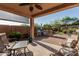This outdoor kitchen features a built-in BBQ grill, refrigerator, bar seating, and a spacious patio for outdoor entertaining at 1322 W Spur Dr, Phoenix, AZ 85085