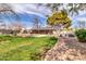 A beautiful backyard featuring a pool, covered patio, solar panels, and brick-lined paths at 2017 E Willis Rd, Gilbert, AZ 85297