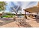 Outdoor oasis featuring a sparkling pool, mature tree, and covered patio perfect for entertaining at 2017 E Willis Rd, Gilbert, AZ 85297