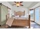Bright bedroom with a wooden bed, a sliding barn door to the closet, and a door to the backyard at 2017 E Willis Rd, Gilbert, AZ 85297