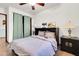 Bedroom with tan tile floors, ceiling fan, a murphy bed and sliding closet doors at 2017 E Willis Rd, Gilbert, AZ 85297