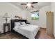 This bedroom offers tan tile floors, a murphy bed, a ceiling fan, and natural light at 2017 E Willis Rd, Gilbert, AZ 85297
