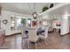 Bright dining room with large windows, a stylish light fixture, and wood-look floors at 2017 E Willis Rd, Gilbert, AZ 85297