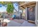 Inviting front entrance featuring a charming patio with seating and a beautifully decorated front door at 2017 E Willis Rd, Gilbert, AZ 85297