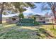 Charming home featuring a well-manicured front yard and eye-catching curb appeal with mature trees at 2017 E Willis Rd, Gilbert, AZ 85297