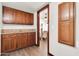 Hallway with wooden cabinets and granite countertops that leads to a bedroom at 2017 E Willis Rd, Gilbert, AZ 85297
