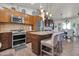 Spacious kitchen with stainless steel appliances, granite countertops, and a center island with seating at 2017 E Willis Rd, Gilbert, AZ 85297