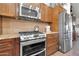 Well-equipped kitchen featuring stainless steel appliances and custom wood cabinets at 2017 E Willis Rd, Gilbert, AZ 85297