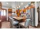 Spacious kitchen featuring wood cabinets, a granite island, and stainless steel appliances at 2017 E Willis Rd, Gilbert, AZ 85297