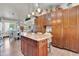 Open-concept kitchen with an island, stainless steel appliances, and custom wood cabinets at 2017 E Willis Rd, Gilbert, AZ 85297