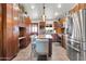 This kitchen features wooden cabinets, a granite island, and stainless steel appliances at 2017 E Willis Rd, Gilbert, AZ 85297