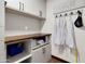 Bright laundry room with upper and lower cabinets, butcher block countertop, and apron rack at 2017 E Willis Rd, Gilbert, AZ 85297