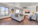Cozy living room with neutral furniture, a ceiling fan, and a large window at 2017 E Willis Rd, Gilbert, AZ 85297