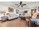 Spacious living room with neutral furniture, a ceiling fan, and wood-look flooring at 2017 E Willis Rd, Gilbert, AZ 85297