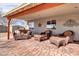 Covered patio with an outdoor seating arrangement, ceiling lights, and a brick-paved floor at 2017 E Willis Rd, Gilbert, AZ 85297