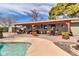 This home's patio features a covered living space and a beautiful swimming pool at 2017 E Willis Rd, Gilbert, AZ 85297