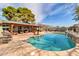 This backyard has a private pool with waterfall features and an adjacent covered patio for relaxing and entertaining guests at 2017 E Willis Rd, Gilbert, AZ 85297
