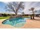 This backyard features a private pool with waterfall and mature landscaping at 2017 E Willis Rd, Gilbert, AZ 85297