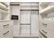Walk-in closet with ample shelving, drawers, and storage space for clothes and accessories at 2017 E Willis Rd, Gilbert, AZ 85297