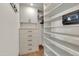 Walk-in closet with ample shelves, drawers, and a safe for clothes and accessories at 2017 E Willis Rd, Gilbert, AZ 85297