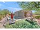Backyard oasis featuring a pool, lush turf, lounge seating, and mature trees at 3060 N Ridgecrest -- # 200, Mesa, AZ 85207
