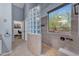 Spacious shower includes desert view window, glass block, and neutral tile surround at 3060 N Ridgecrest -- # 200, Mesa, AZ 85207