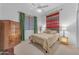 Bright bedroom featuring colorful southwestern design, soft lighting, and a spacious closet at 3060 N Ridgecrest -- # 200, Mesa, AZ 85207