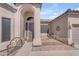 Charming home entry with an arched doorway, custom iron accents, and desert landscaping at 3060 N Ridgecrest -- # 200, Mesa, AZ 85207