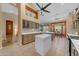 Modern kitchen features an island, stainless steel appliances, and an adjacent dining area with desert views at 3060 N Ridgecrest -- # 200, Mesa, AZ 85207