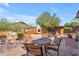 The backyard patio features a built-in fireplace, BBQ, and lounge area surrounded by desert landscaping at 3060 N Ridgecrest -- # 200, Mesa, AZ 85207
