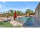 A sparkling pool is surrounded by desert landscaping and a built-in BBQ for outdoor enjoyment at 3060 N Ridgecrest -- # 200, Mesa, AZ 85207