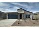 Charming single-story home featuring a two-car garage, neutral color palette, and low-maintenance front yard landscaping at 36956 W Santa Maria St, Maricopa, AZ 85138